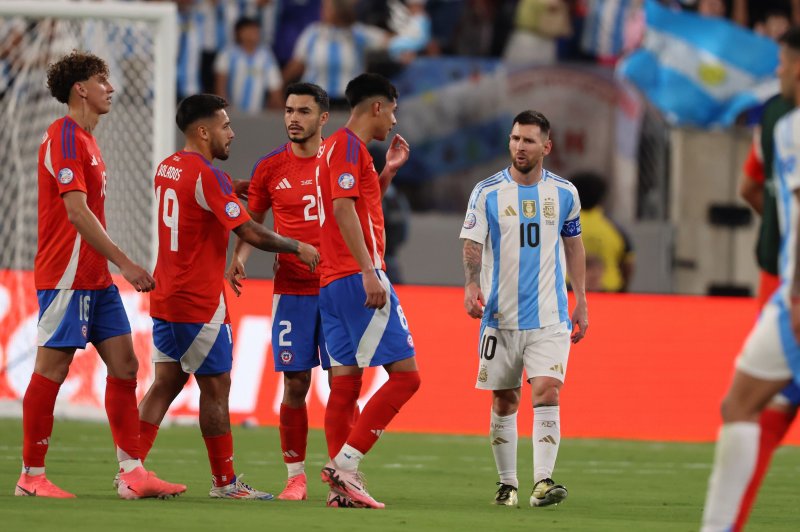 Argentina forward Lionel Messi (R) walks past Chilean players after a 1-0 Copa America victory Tuesday at MetLife Stadium in East Rutherford, N.J. Photo by Justin Lane/EPA-EFE