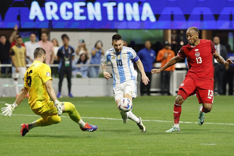 Lionel Messi (C) of Argentina dribbles in front of Canada goalie Maxime Crepeau (L) during a 2024 Copa America group-stage match Thursday at Mercedes-Benz Stadium in Atlanta. Photo by Erik S. Lesser/EPA-EFE