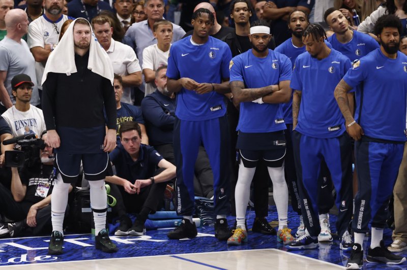 Dallas Mavericks guard Luka Doncic (L) stands on the bench after fouling out during a loss to the Boston Celtics in Game 3 of the NBA Finals on Wednesday in Dallas. Photo by Adam Davis/EPA-EFE