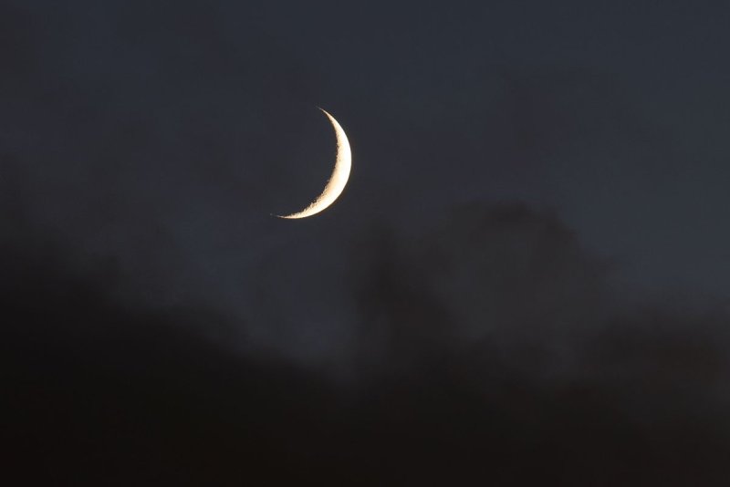 The crescent moon (pictured over New York City in 2023) will be aligned with three planets this weekend. File Photo by John Angelillo/UPI