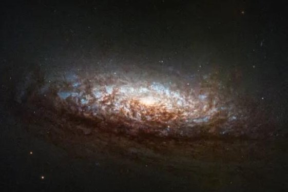 NASA has released the fist galactic image captured by the Hubble Space Telescope's new one-gyroscope pointing mode. An issue with one of the gyros took the telescope offline for several weeks. Photo by David Thilker (Johns Hopkins University)/ NASA, ESA, STSci