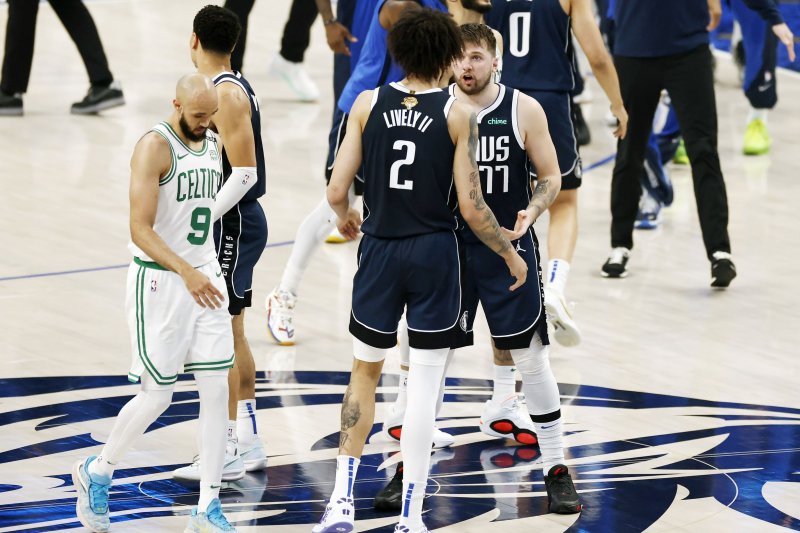 Dallas Mavericks guard Luka Doncic (R) talks with center Dereck Lively II (C) during Game 4 of the NBA Finals against the Boston Celtics on Friday in Dallas. Photo by Adam Davis/EPA-EFE