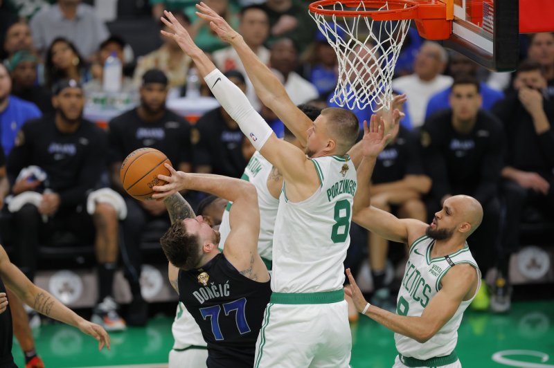 Boston Celtics center Kristaps Porzingis (C) blocks a shot by Dallas Mavericks guard Luka Doncic (L) during the first half of Game 1 of the 2024 NBA Finals on Thursday in Boston. Photo by C.J. Gunther/EPA-EFE