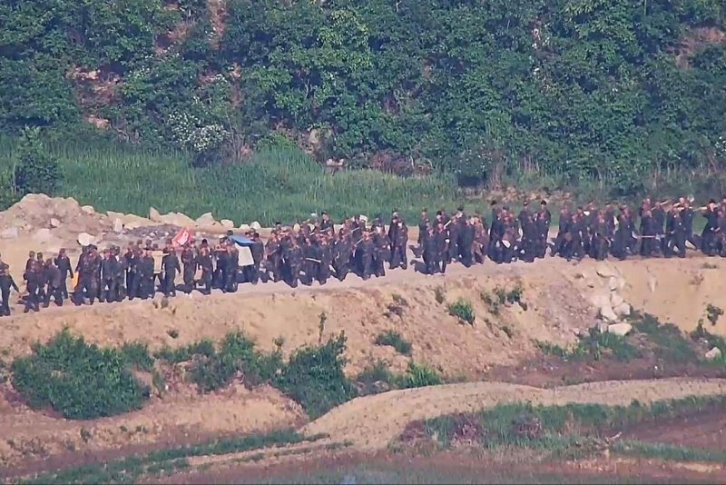 North Korean soldiers briefly crossed the border inside the DMZ for the third time in weeks, prompting South Korean troops to fire warning shots, the South's Joint Chiefs of Staff said Friday. The North's soldiers are conducting construction work at the frontline, as seen in this photo provided by the South Korean military on June 18. Photo courtesy of Republic of Korea Defense Ministry