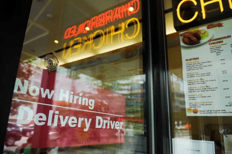 A "Now Hiring" sign was displayed in the window of a restaurant in the Tenlytown neighborhood of Washington D.C. on August 12, 2010. First-time jobless claims fell for the second straight week, the Labor Department said on Thursday. File Photo by Alexis C. Glenn/UPI